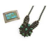 A native American silver necklace with turquoise floral shaped centrepiece, and a silver and