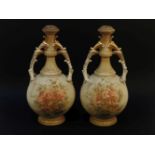 A pair of late 19th century Stellmacher twin handled porcelain vases, the blush ivory ground with