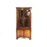 A mahogany concave cabinet, fitted pair of astragal glazed doors, above cupboards, 89cm wide, 50cm
