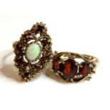 A 9ct gold opal and garnet lozenge shaped cluster ring, and a 9ct gold three stone garnet ring, 11.