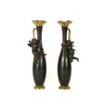 A pair of modern bronze mounted ewers, late 20th century, modelled with cherubs clinging to the