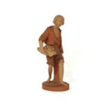 A Watcombe pottery figure, of a woodsman holding an axe and a nest of birds, printed mark, 37cm