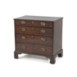 A George III mahogany chest of small proportions, fitted four graduated drawers on bracket feet,