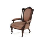 A Victorian walnut open armchair, having an oval pad back above stuff over seat, in pink damask,