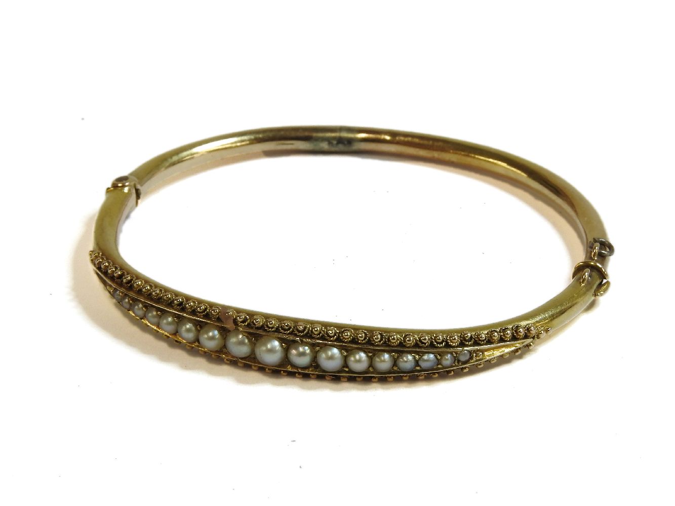 A Victorian gold hinge bangle, set with a graduated row of split pearls, 6.80g