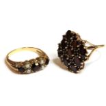 A 9ct gold garnet and lozenge shaped cluster ring, a 9ct three stone garnet and cultured split pearl