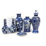 A pair of Chinese blue and white vases, of globular form with long neck, painted with panels of