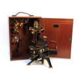 A lacquered brass microscope, with various extra lenses, cased, labelled W Watson & Sons