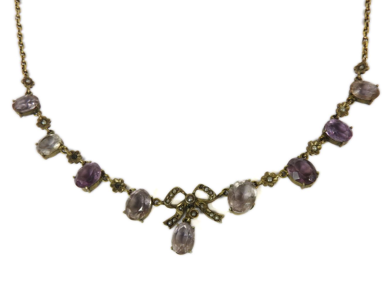 An Edwardian rolled gold necklace, with split pearl set bow and oval cut amethyst centrepiece, clasp