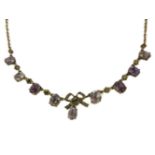 An Edwardian rolled gold necklace, with split pearl set bow and oval cut amethyst centrepiece, clasp