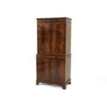 A mahogany cocktail cabinet, having a pair of panel doors enclosing illuminating sycamore