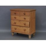 A stripped pine chest of drawers
