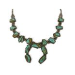 A native American silver and turquoise freeform matrix tablet squash blossom necklace