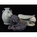 A Chinese crouching dog and two further items, tallest 19.5cm