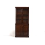 A 19th century mahogany bookcase cabinet, the upper section with glazed doors opening to reveal