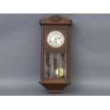 A 1930's oak wall, clock with three train chiming movement striking on gongs, 81cm high
