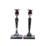A pair of silver candlesticks, Birmingham assay of classical design, Poor condition, marks obscured.