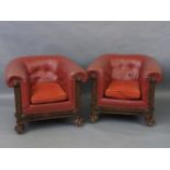 A pair of early 20th century red leatherette upholstered club armchairs, with button backs and