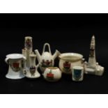 A collection of approximately forty items of crested china, a glass paperweight and an inlaid dish