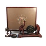A late 19th century brass table gong on elephant supports, a brass incense burner, a pewter dish and