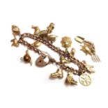A gold hollow curb link charm bracelet, with twelve assorted gold charms, to include a 9ct gold