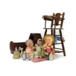 A collection of half dolls, bisque head and other later dolls, a cradle and a high chair
