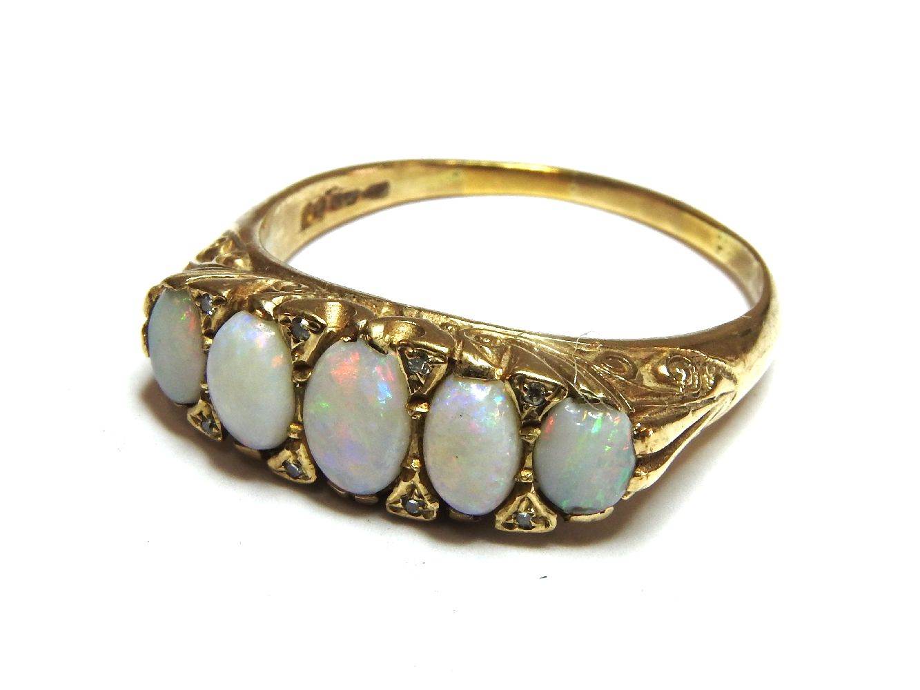 A five stone opal ring, with diamond set points, 6.00g