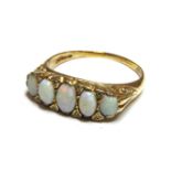 A five stone opal ring, with diamond set points, 6.00g