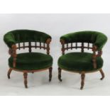 A pair of late Victorian horseshoe backed tub chairs, overstuffed upholstered seats and ring