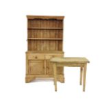 An early 20th century pine dresser, with open shelves above drawers and cupboards, a similar pine