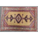 A hand knotted Caucasian rug, the brown field with central pendant and multi border