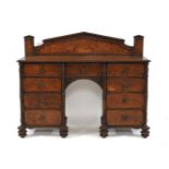 A burr oak sideboard/serving table, with a carved arched back, over eight drawers, 146cm wide,
