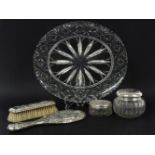 A silver topped three piece dressing table set, hallmarked, with embossed angel portrait decoration,