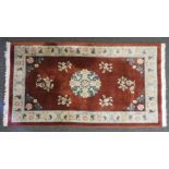 Two 20th century red ground Chinese carpets, 150cm x 240cm and 130cm x 205cm, approximately