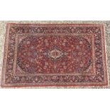A hand knotted Persian Tabriz rug, the red and navy fields with all over foliage decoration and