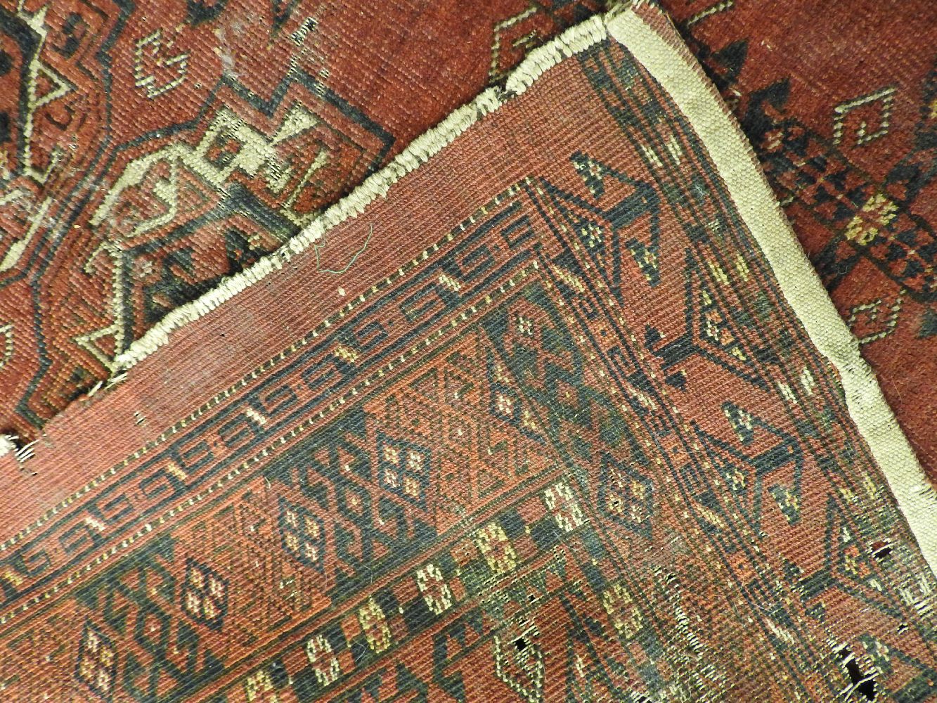 A Bokhara rug, the red fields with repeated geometric decoration and one other similar (both AF) - Image 4 of 4
