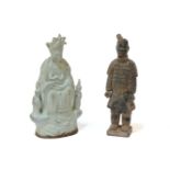 A probably 19th century Chinese qingbai glazed figure of a deity, flanked by children, 26.5cm