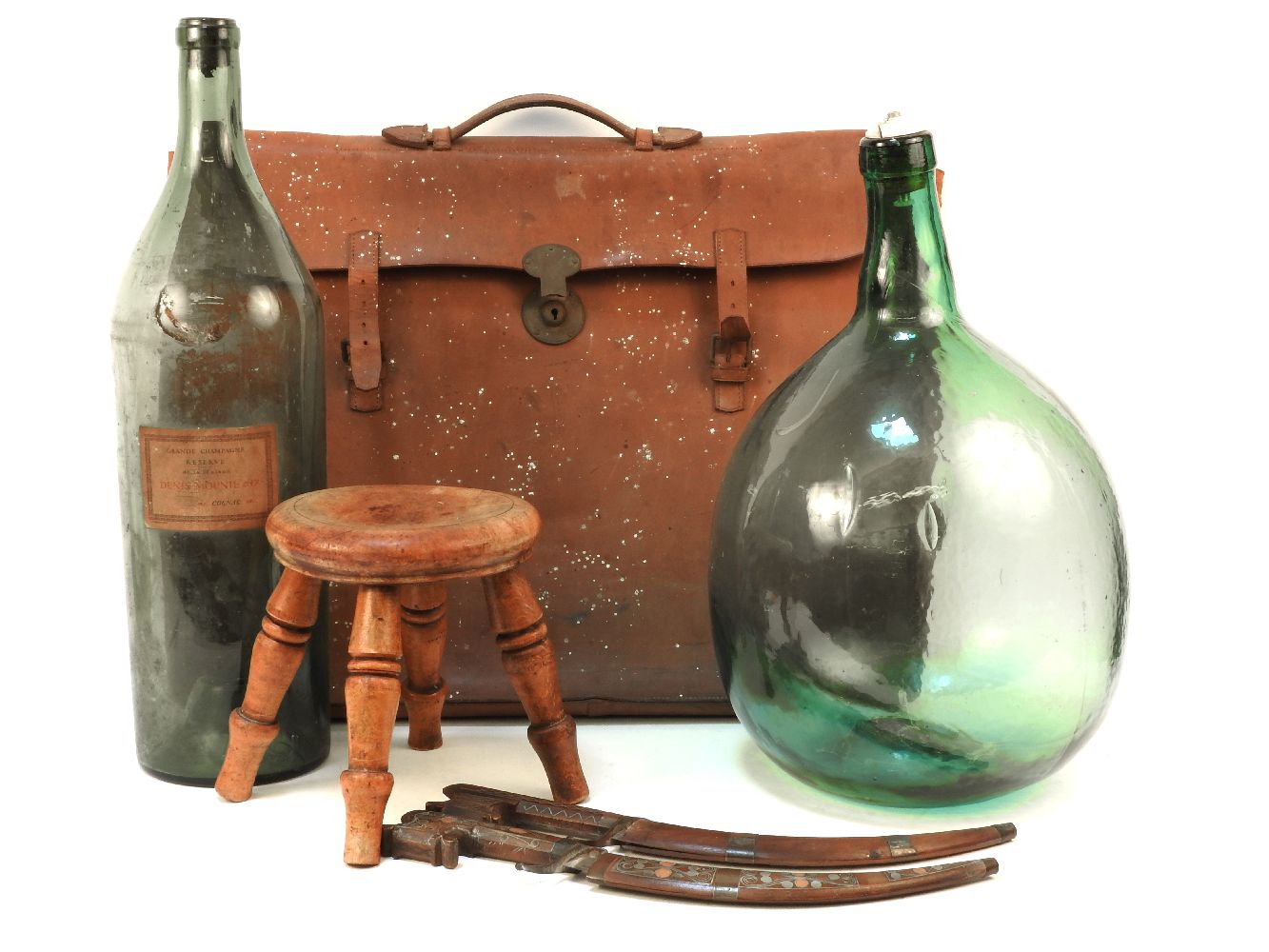 A quantity of various miscellaneous items to include two large green bottles, a leather attache