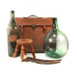 A quantity of various miscellaneous items to include two large green bottles, a leather attache
