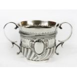 A silver twin handled loving cup, maker's mark J H, London, 1897, half fluted and embossed with