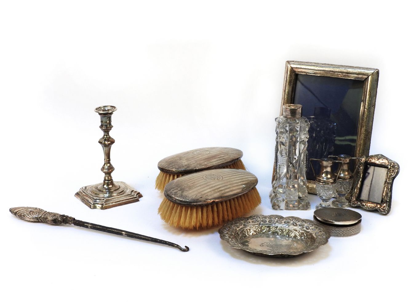 A collection of various silver items to include photograph frames, scent bottles and candlesticks