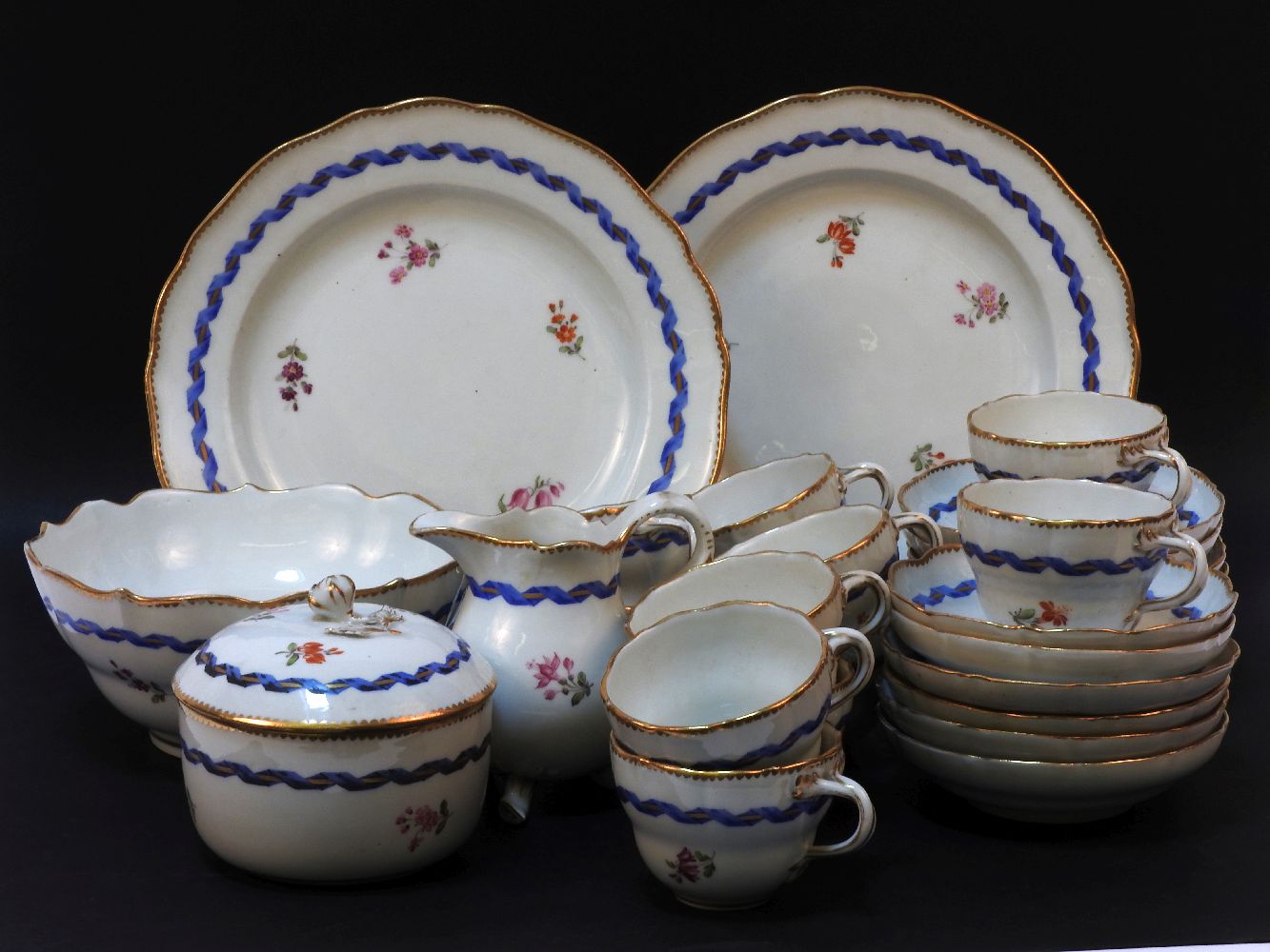 A Meissen tea set, comprising twelve cups and saucers, milk, sugar bowl and cover, and slops bowl,