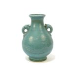 A 19th century Chinese celadon glazed vase, the flaring rim flanked by moulded elephant ring