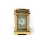 A small brass carriage clock8cm high, to top of handle, in a larger leather case.
