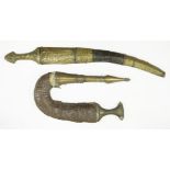 A janbiya, with a metal inset handle and ornate brass and leather sheath, andanother, with an ornate