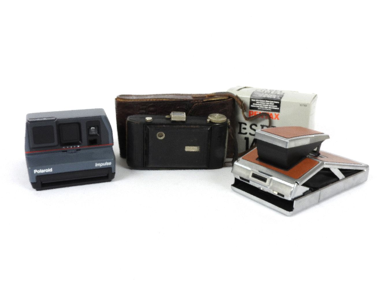 Four cameras including a Polaroid SX-70, a Polaroid Impulse, a Hapo 45, and a Pentax ESPIO 140-V