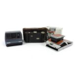 Four cameras including a Polaroid SX-70, a Polaroid Impulse, a Hapo 45, and a Pentax ESPIO 140-V