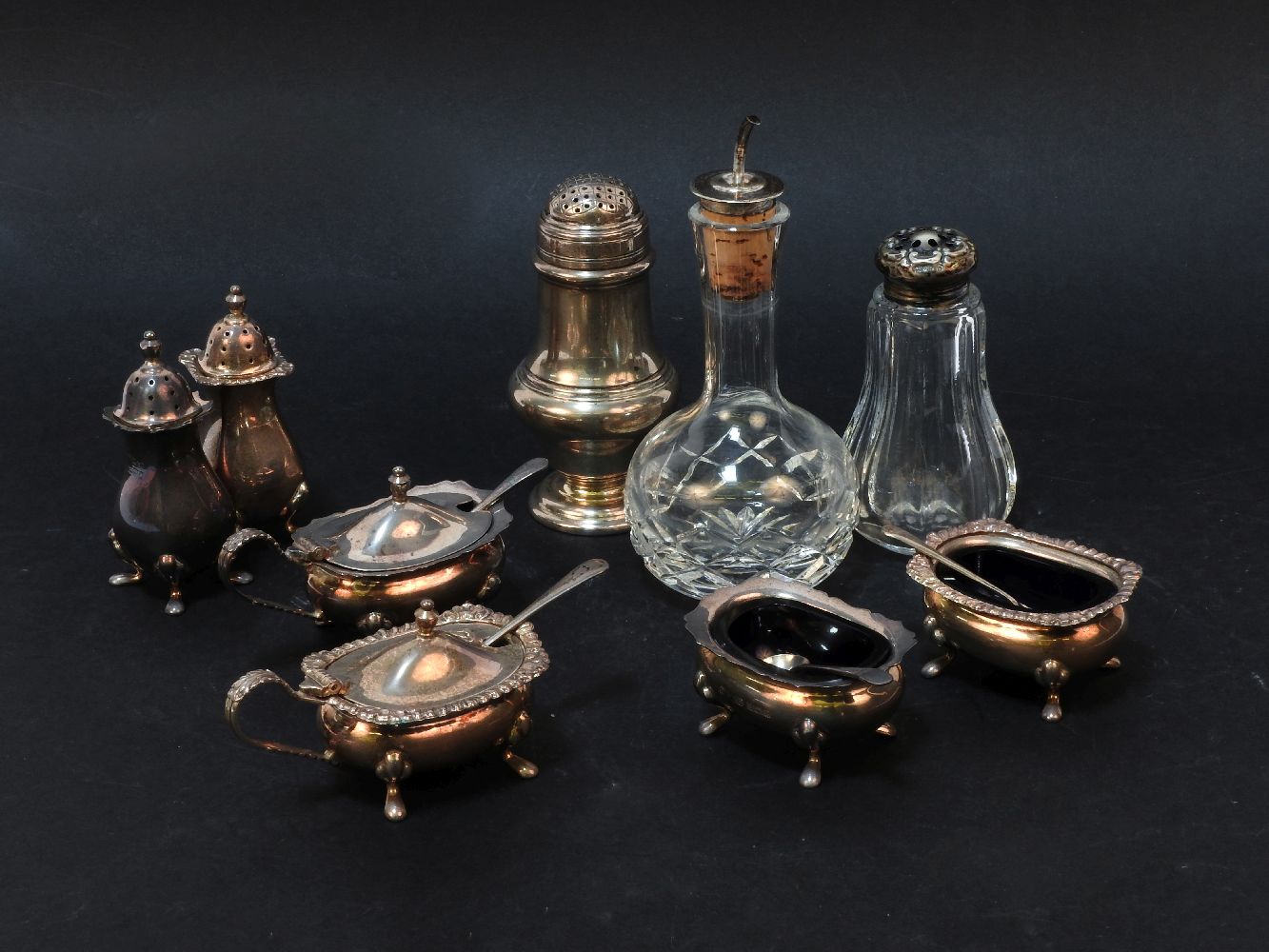 A silver cruet set, together with one other, a caster, vinegar bottle, etc