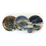 Two highland pottery chargers, each 29cm diameter, decorated with landscape scenes, together with