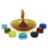 A large quantity of moulded glass furniture stands/tea light holders, coloured and clear, together